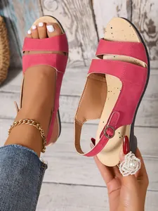 Detailed close-up view of rose red wedge sandals with adjustable buckle ankle strap