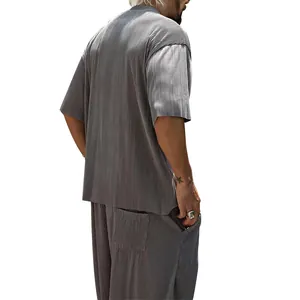 Men's stylish grey pleated two-piece set featuring short sleeve shirt and loose pants