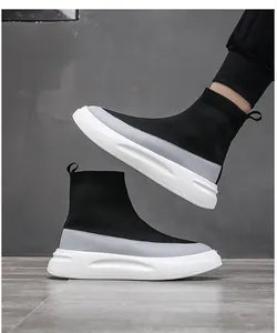 Detail view of black breathable knit high-top sock sneakers with thick white soles.