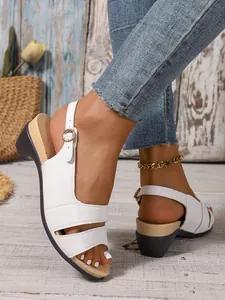 Detail shot of women's white leather wedge sandals with buckle strap and fish mouth design