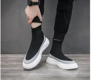 Detailed close-up view of men's black high-top fly-knit sock sneakers with white sole