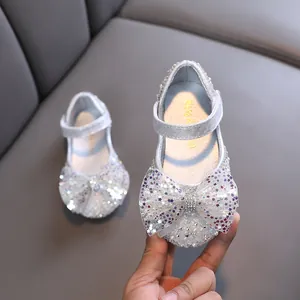 Elegant silver glitter girls princess shoes featuring a large star sequin bow and strap