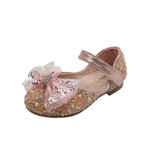 Elegant pink sequined princess shoes for girls featuring a large sparkling bow for parties.