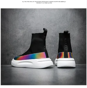 Detail view of high-top fly-knit sock sneakers with colorful rainbow gradient panels.