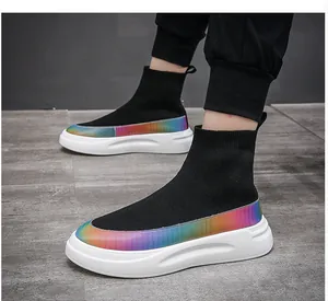 Close-up of black knit sock sneakers with vibrant rainbow gradient and thick white soles