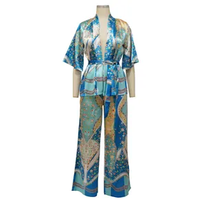 Detailed view of a two-piece women's floral print satin set with wide-leg trousers