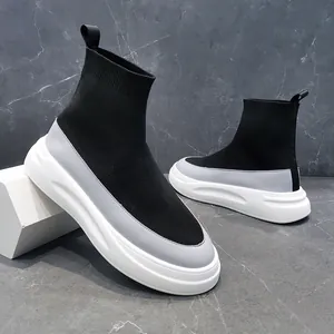 High-top black and grey fly-knit sock sneakers with thick white soles.