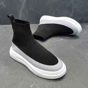 Detailed view of black breathable fly-knit high-top sock sneakers with white soft sole