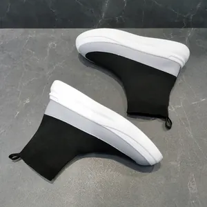 Detailed top view of breathable black and white fly-knit high-top sock sneakers.