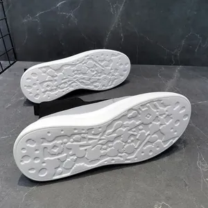 Detail view of men's breathable knit sock sneakers with non-slip sole pattern.