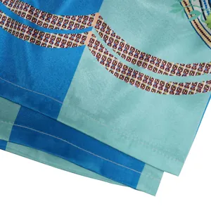 Close-up of blue satin printed fabric with geometric patterns and neat stitching details.