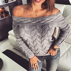 Detail view of grey off-the-shoulder cable-knit sweater for women in a cozy home setting
