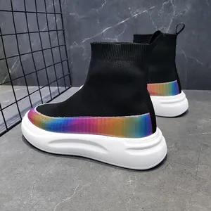 Detail view of high-top knit sneakers with iridescent rainbow strip and white sole.