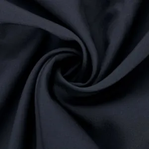 Macro view showing the fine weave and dark blue texture of the traditional robe fabric.