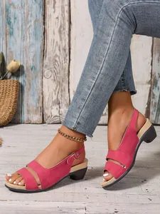 Detail view of pink peep-toe sandals with adjustable buckle strap and low block heel.