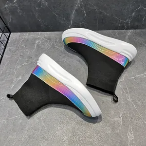 Close-up of men's black high-top sock sneakers with vibrant rainbow gradient detail