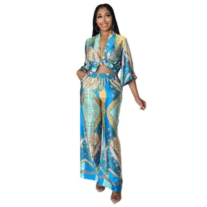 Full view of women's two-piece set with elegant blue floral print and wide-leg pants