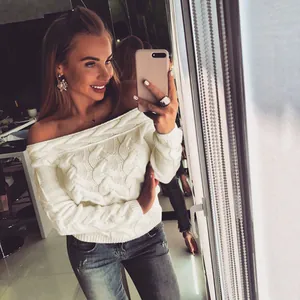 Chic white off-the-shoulder cable knit sweater featuring a chunky textured pattern