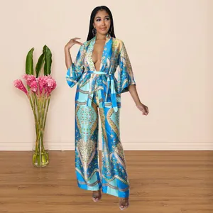 Elegant faux silk two-piece set with vibrant prints and wide-leg trousers on model
