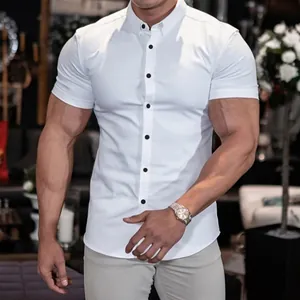Detail shot of a white muscle fit short sleeve shirt featuring contrasting buttons.