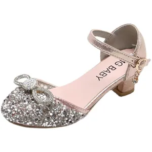 Sparkling pink sequin girls' dress shoes with rhinestone bow and ankle strap for party.