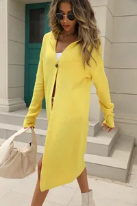 Close-up of vibrant yellow long knit hooded cardigan showing textured knit and fit