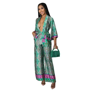 Detailed view of elegant women's two-piece faux silk set with green paisley print