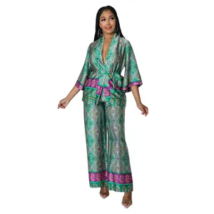 Front full body view of women's elegant faux silk two-piece set with green paisley print