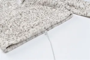 Close-up detail of leopard print plush sweatshirt with adjustable drawstring hem