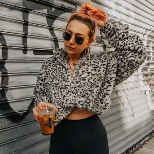 Woman wearing a leopard print fluffy fleece hoodie in an urban street fashion setting