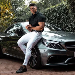 Muscular fit short sleeve polo shirt for men in black shown on a model outdoors.