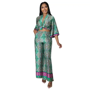 Detailed view of women's green paisley printed silk-like two-piece set with wide-leg pants