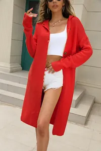 Woman wearing a long red hooded knit cardigan with white crop top and shorts