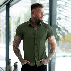 Muscle fit short sleeve button-down shirt in olive green shown on a muscular male model
