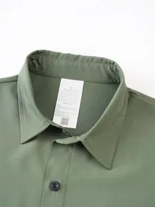 Detail of a men's green stretch short-sleeve shirt neckline showing fabric texture
