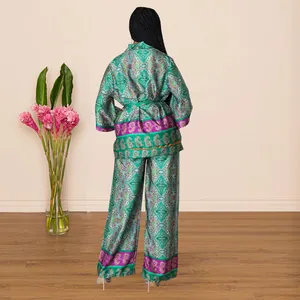 Back view of elegant green paisley print satin pajamas set with wide-leg trousers.