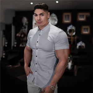 Close-up view of a professional men's muscle fit light grey short sleeve button-down shirt