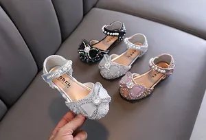 Sparkly girls' princess shoes with rhinestone bows and pearl straps in multiple colors.