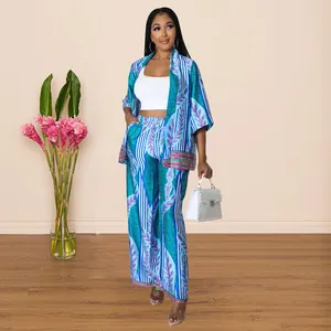 Full body view of a stylish two-piece faux silk printed kimono and wide-leg pants set