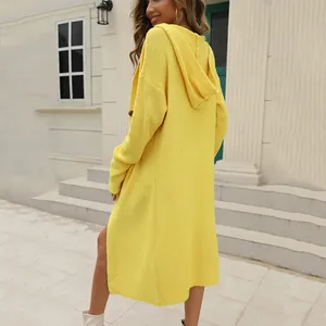 Long yellow hooded knitted cardigan for women shown in a stylish outdoor setting