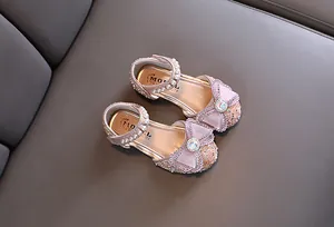 Elegant pink sparkling girls' princess shoes featuring bowknot and pearl strap details