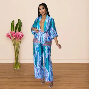 Full-length view of a woman wearing a blue floral printed silky two-piece lounge set.