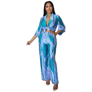 Vibrant blue and green printed two-piece set with tie-front top and wide-leg trousers