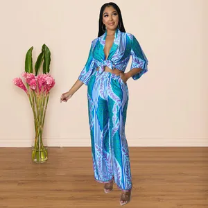 Elegant full-body view of a blue printed two-piece outfit in a modern indoor setting