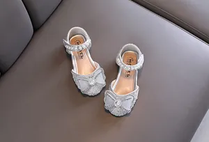 Sparkling silver girl princess shoes with elegant bow, pearl and rhinestone details