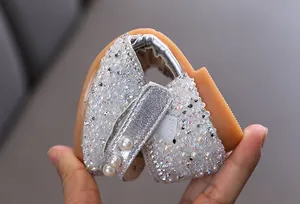 Detail showing the flexible sole of a silver glitter girl's princess shoe with pearls