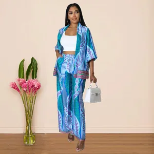 Detail view of women's two-piece set featuring printed kimono top and wide-leg pants