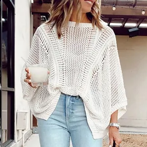 Close-up detail of a white loose mesh hollow-out knit sweater perfect for beach resort cover-ups