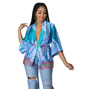 Fashionable bohemian printed silk-like robe top with deep V-neck and waist tie.