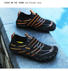 Close-up of children's non-slip black water shoes with orange stripes